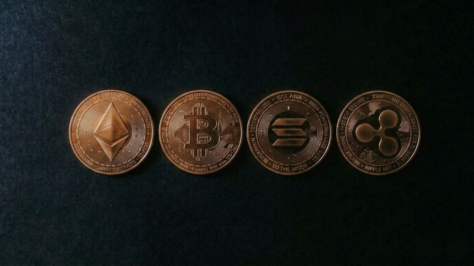 Bitcoin Leads Crypto Market Back to $3 Trillion as Traders Return to Risk Four copper cryptocurrency coins—Ethereum, Bitcoin, Solana, and XRP—lined up on a dark surface; altcoins