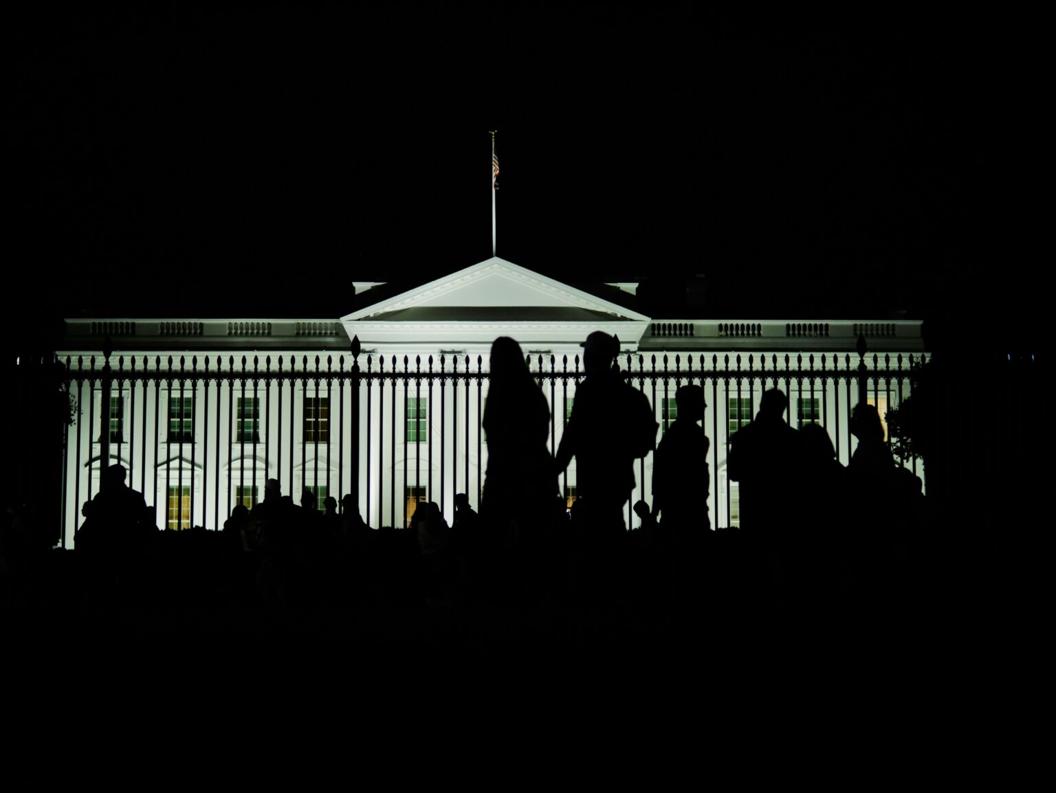 Xinbi Crypto Freeze Hits $52.8 Million as U.S. Targets Telegram Scam Bazaar Silhouetted visitors gather before the illuminated White House at night